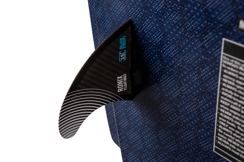 A black Ronix 2024 H.O.M.E. Carbon Pro M50 Wakesurf Board with a blue label on it, featuring the M50 button fin system for enhanced performance and designed specifically for wakesurfers.