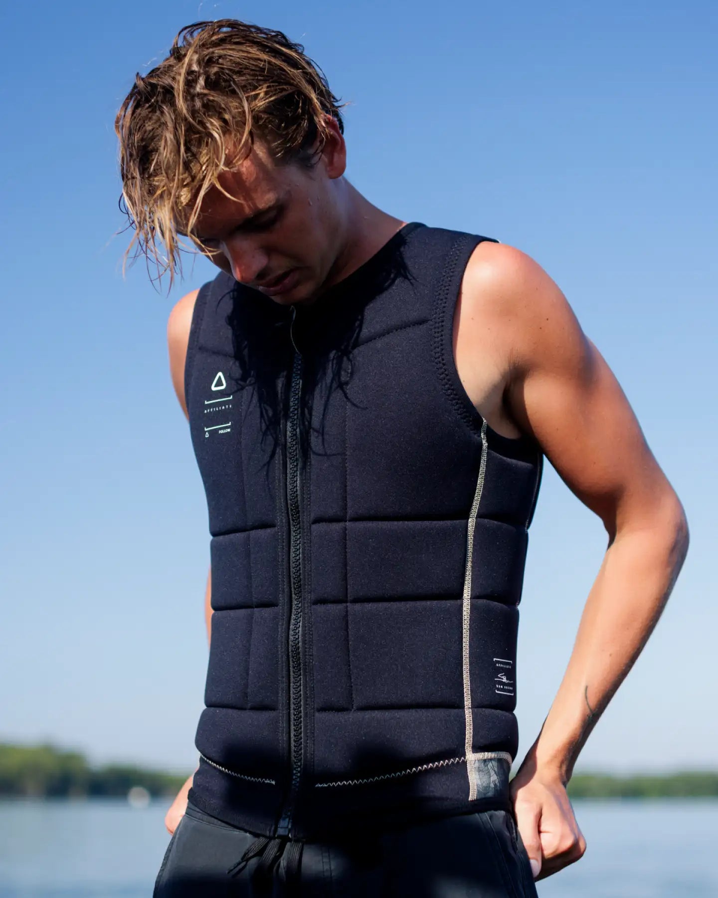 Sam Brown poses wearing the Follow Affiliate Men's Impact Vest - Black