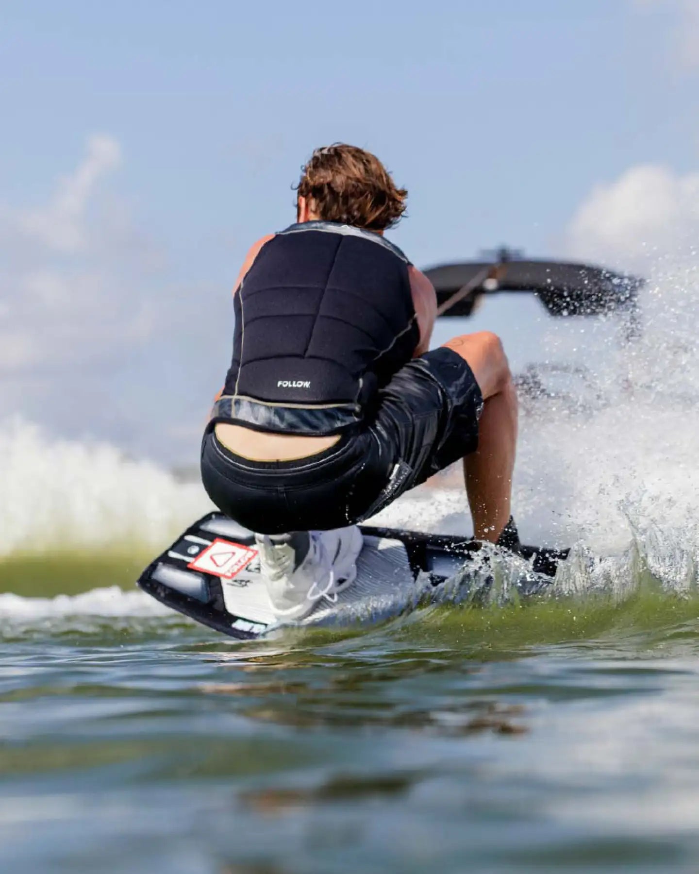 Sam Brown wakeboards in the Follow Affiliate Men's Impact Vest - Black