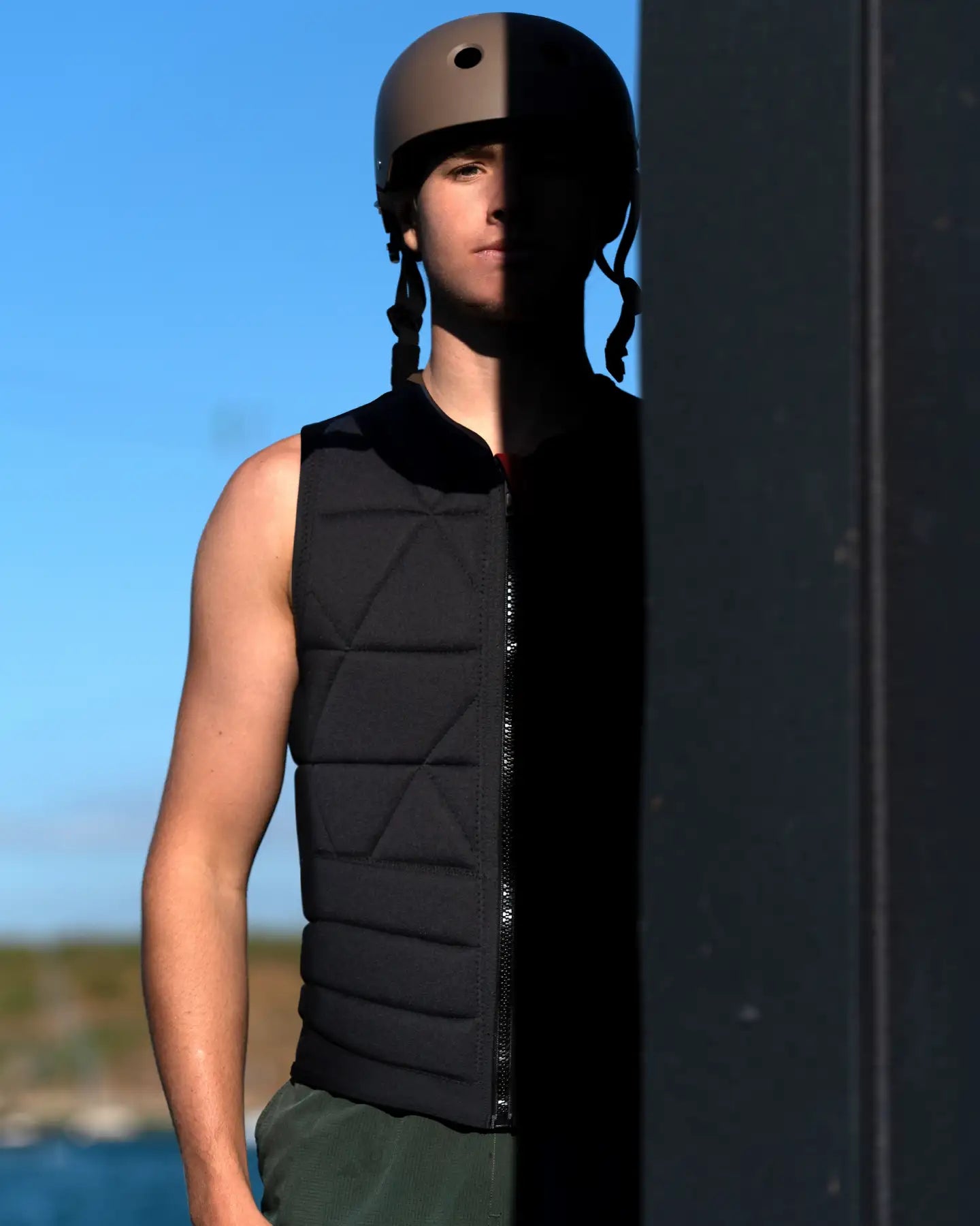 Gavin Stuckey poses in the Follow Love nor Money Men's Impact Vest - Black