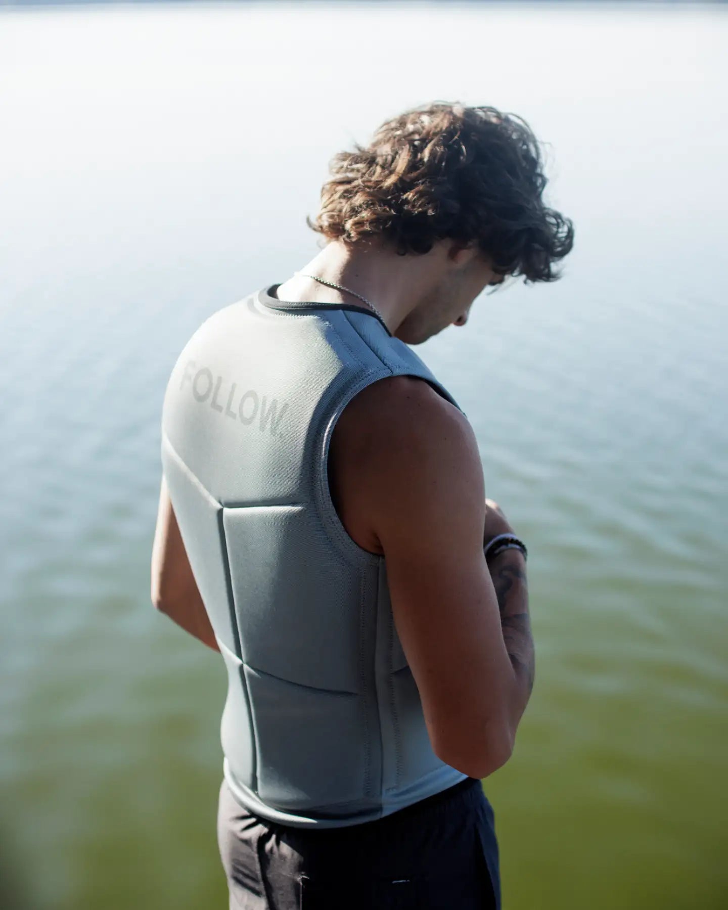 Jamie Huser poses in the Follow Section Men's Impact Vest - Stone