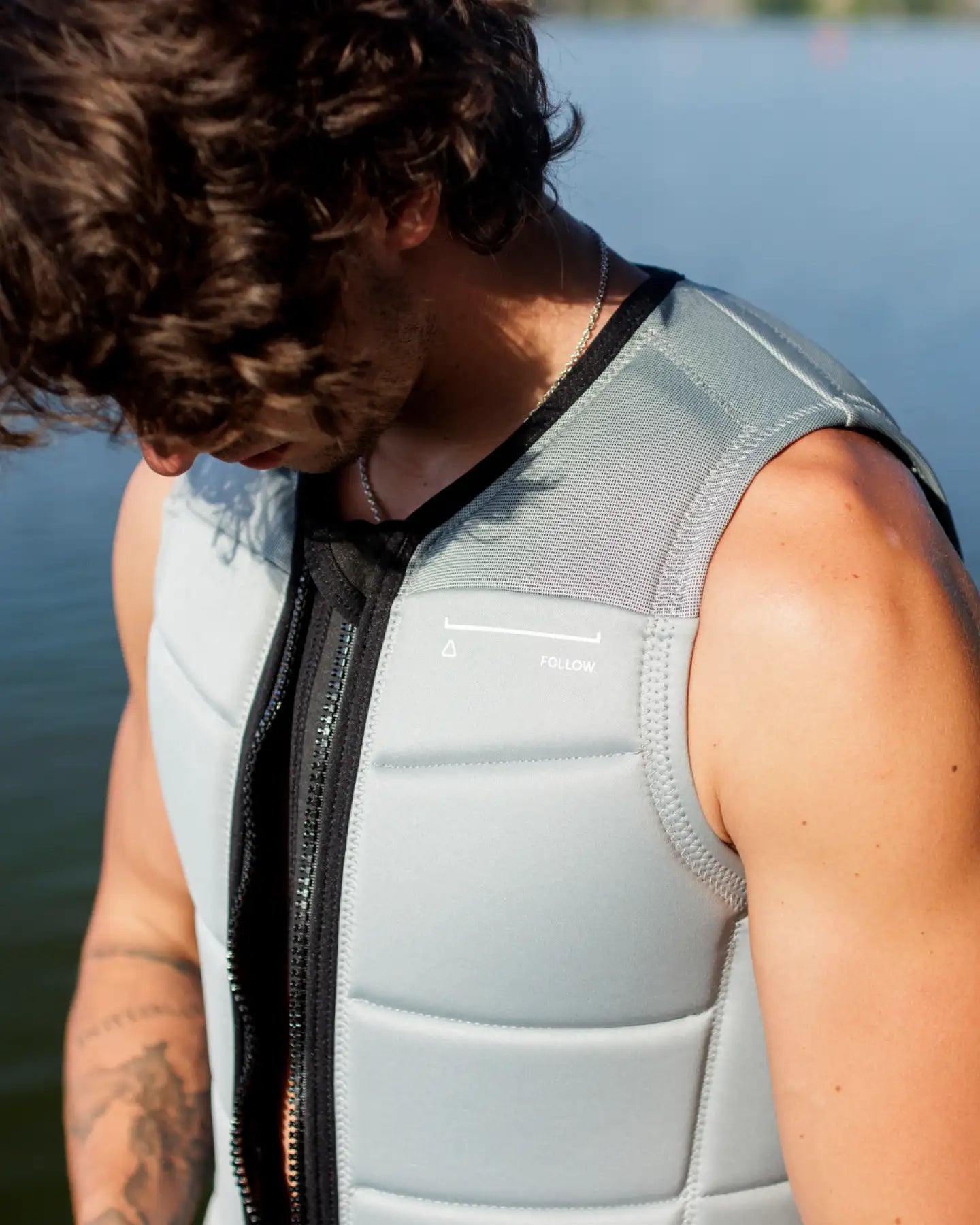 Jamie Huser zips up the Follow Section Men's Impact Vest in Stone