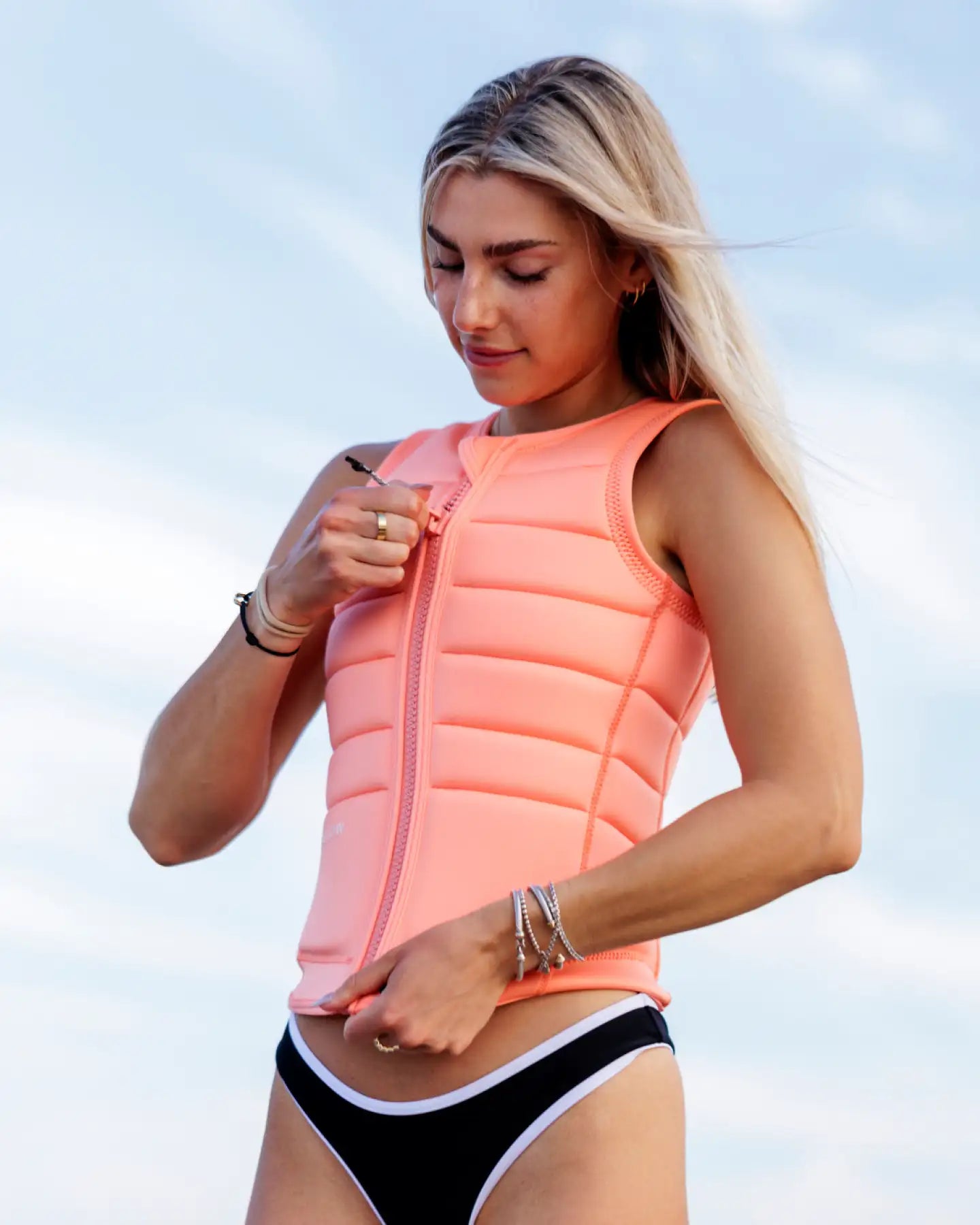 Cassidy Gale zips up the Follow Total Womens Impact Vest - Melon