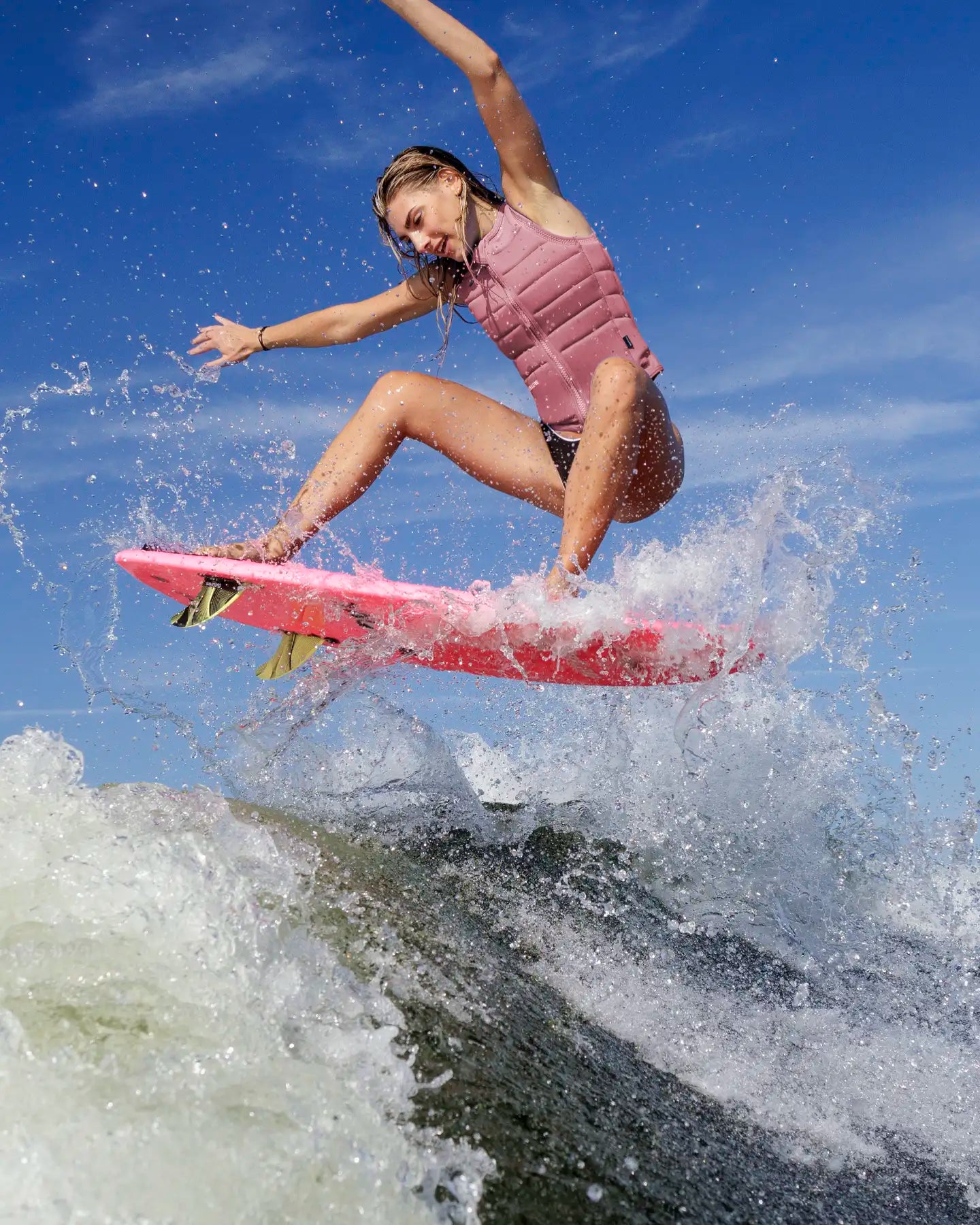 Cassidy Gale wakesurfs in the Follow Total Womens Impact Vest - Pink