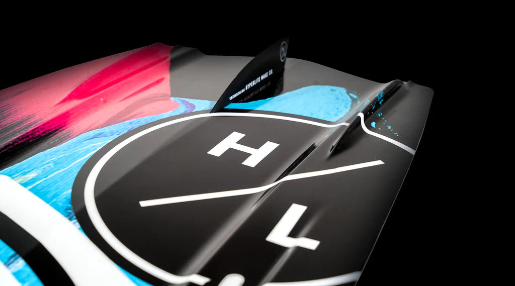 Close-up of the Hyperlite 2025 Eden Jr Wakeboard tail, showcasing its colorful asymmetrical design with prominent black, white, red, and blue sections. Perfect for mastering toe-side jumps while showing off your style on the waves.