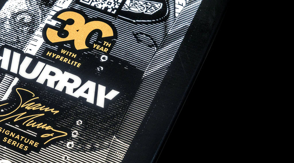 Close-up of a black and white board design featuring the Hyperlite 2025 Murray Pro Wakeboard text in gold, highlighting its advanced Biolite 3 Core for superior performance.