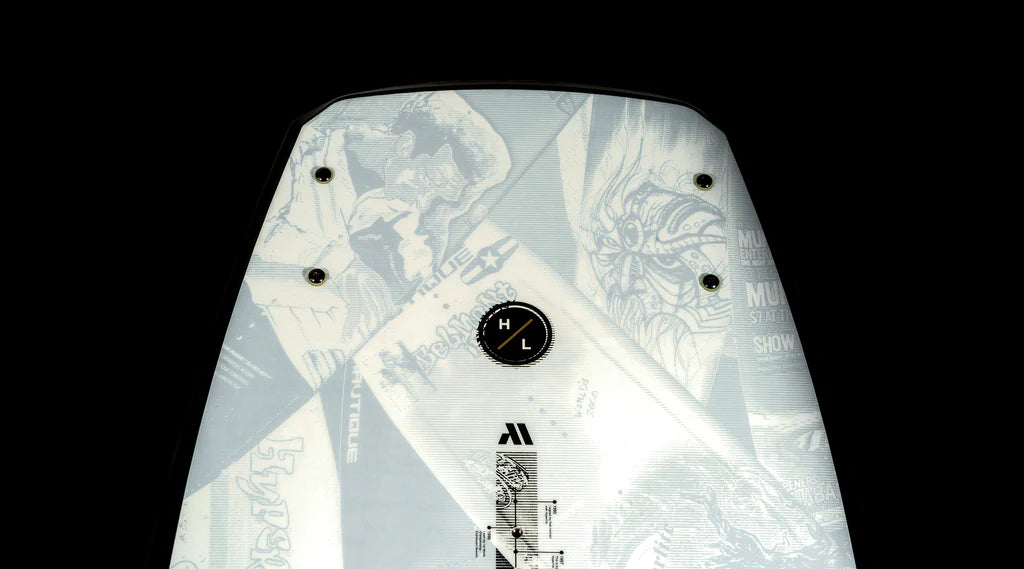 Close-up of the Hyperlite 2025 Murray Pro Wakeboard, showcasing a monochrome design adorned with various graphics and logos. The Biolite 3 Core construction is highlighted alongside the 3-Stage Rocker, and the surface features bolt holes and a central emblem from Hyperlite.