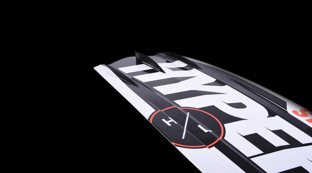 Close-up of a wakeboard dubbed the Hyperlite 2025 State Jr, showcasing an eye-catching asymmetrical design with a decorative circle set against a black background.