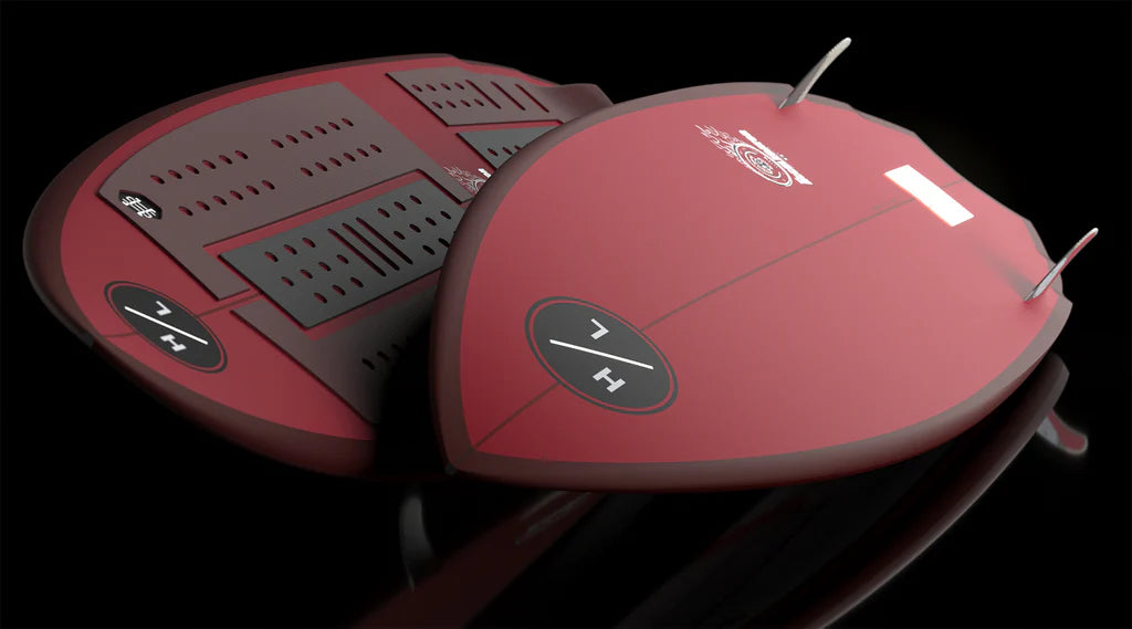 Two sleek Hyperlite Accelerator Wakesurf Boards 2026 by Hyperlite with black traction pads, fins, and white logos are displayed side by side on a reflective black surface, one facing up, the other down.