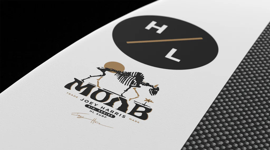 A close-up of the Hyperlite Moab Wakesurf Board 2026 shows a black circle with "H/L" in white and gold, a cattle skeleton graphic above "MOAB," and additional Hyperlite branding and a signature below.