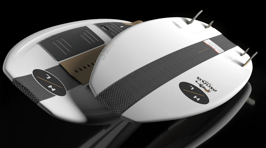 Two white Hyperlite Moab Wakesurf Boards 2026 with black textured stripes, fins, and foot pads are displayed against a black background. Both boards feature “7 H” in black circles.