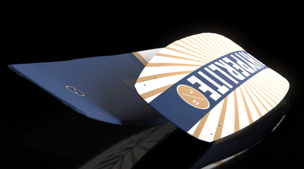 Two curved, blue and white Hyperlite Murray Pro Wakeboards with Team OT Bindings 2026 rest on a glossy black surface, featuring bold HYPERLITE text, gold sunburst patterns, and advanced Biolite 3 Core construction.