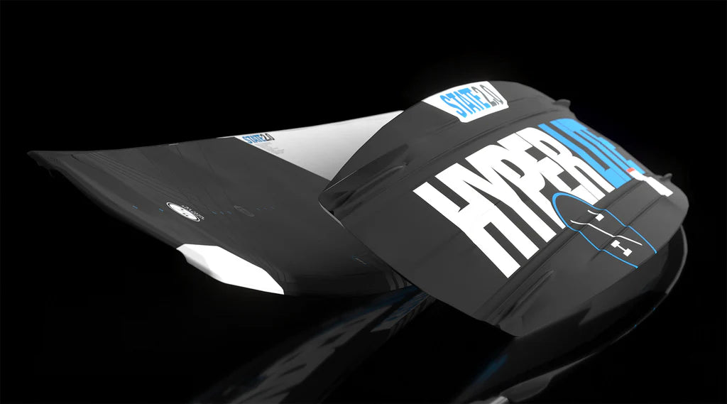 The Hyperlite State 2.0 Wakeboard 2026 features a black and white asymmetrical design with "HYPER" and blue "LITE" text, shown on a black background—ideal for water sports like toe-side wake jumps.