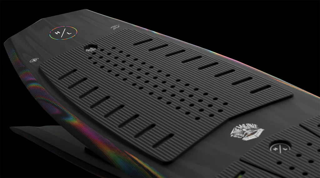 Close-up of the Hyperlite Time Machine Wakesurf Board 2026, featuring a sleek black design, textured grip pads, colorful edges, and bold Hyperlite logos—ideal for wakesurfing fans, set against a dark background.