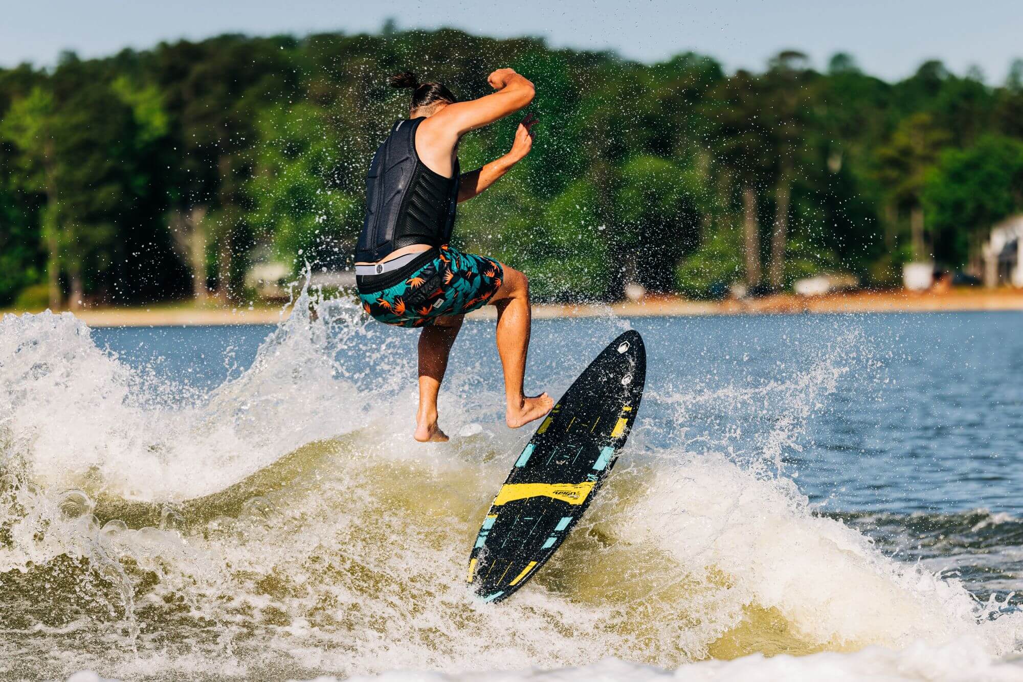 A man riding a wave on a Liquid Force 2024 Reign Pro Wakesurf Board (Pre-Order) made with Full Carbon Layup.