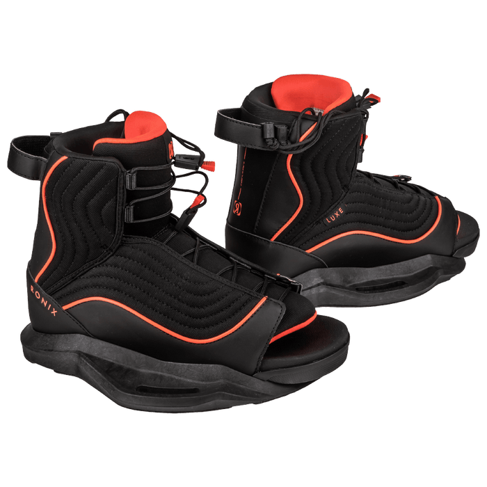 The Ronix 2025 Krush Wakeboard with Luxe Bindings in black features red accents and open toes, showcased against a transparent backdrop.
