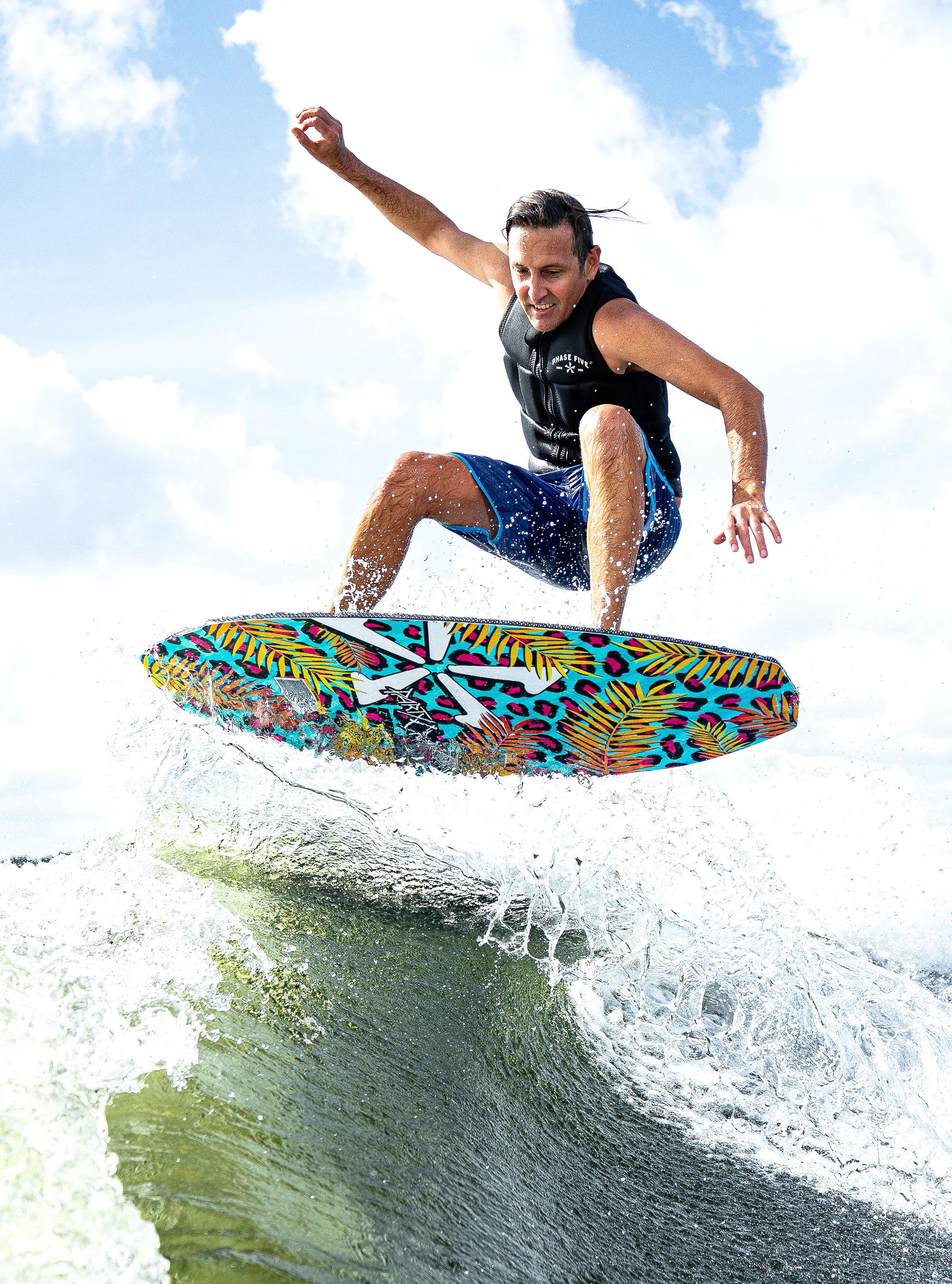 Athlete gets some air off the wake on his Phase 5 2025 Party Crasher Wakesurf Board