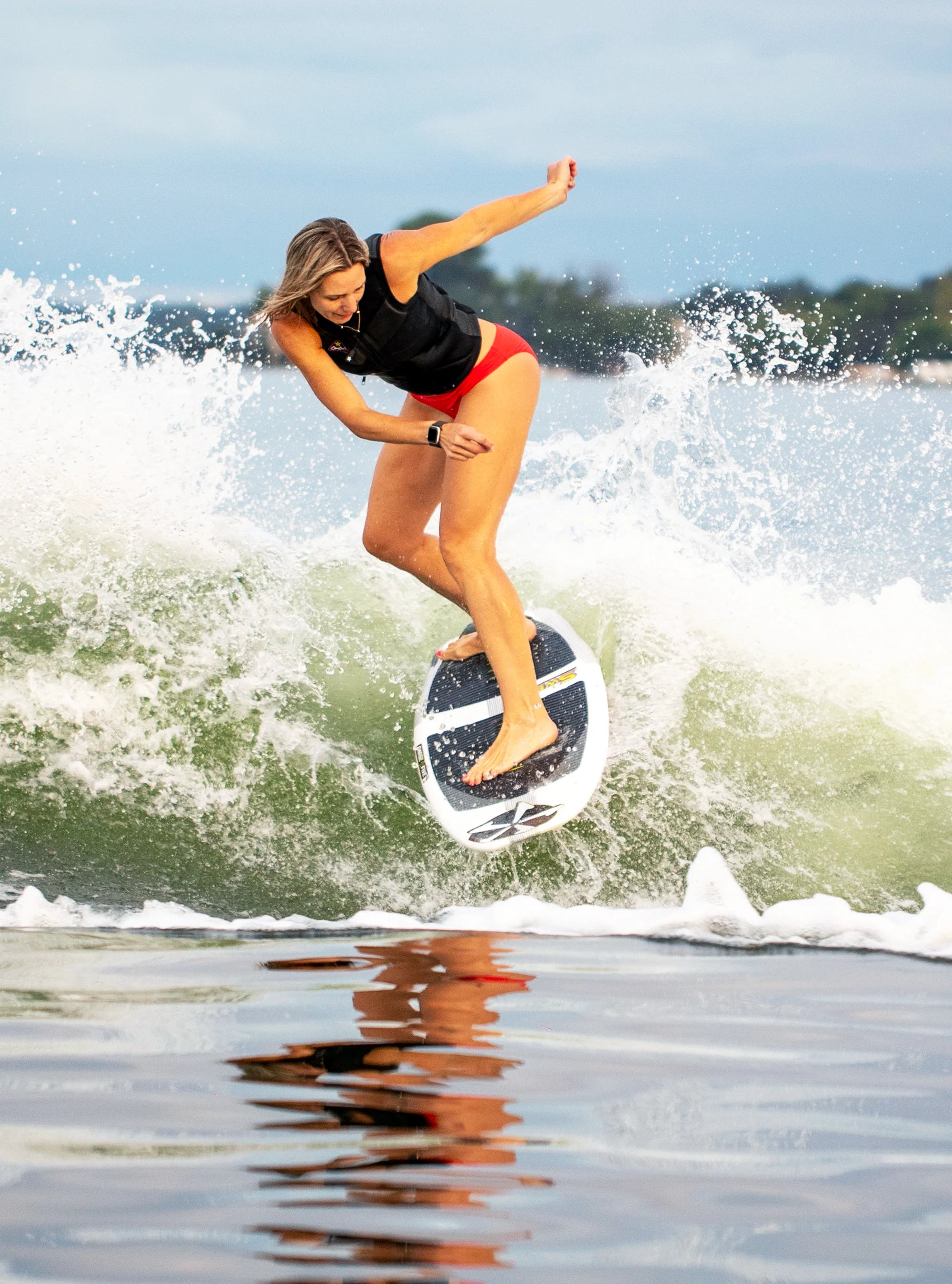 Stacia Bank does a back side turn on the wake riding her Phase 5 2025 Swell Wakesurf Board