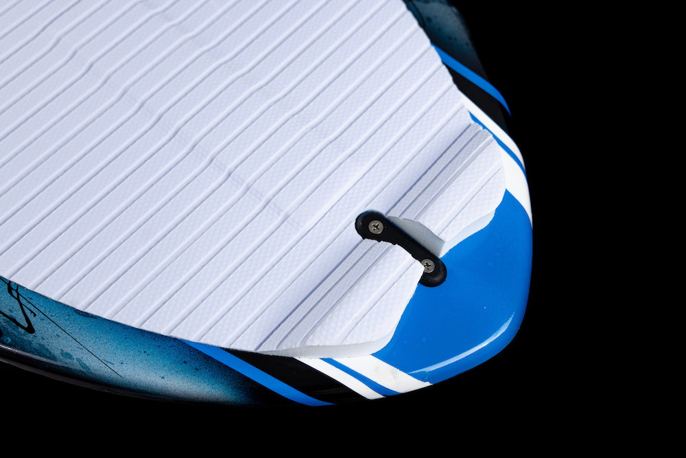 Close-up of the tail section of the Phase 5 Scamp Wakesurf Board 2026 by Phase 5, featuring a blue and white design, textured white traction pad, and black leash attachment against a black background.