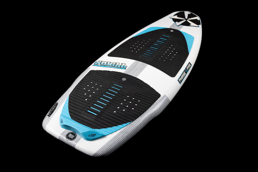 The Phase 5 Swell Wakesurf Board 2026 by Phase 5 is a white performance surf style board with blue and black accents, textured black grip pads, blue lines, and branded decals, shown against a black background.