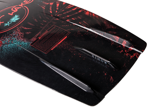 Close-up of the Ronix 2025 Krush Wakeboard | Luxe Bindings, highlighting its elegant black design accented with bold red and turquoise details. It includes fins and a safety warning label, providing assurance as you ride the waves.
