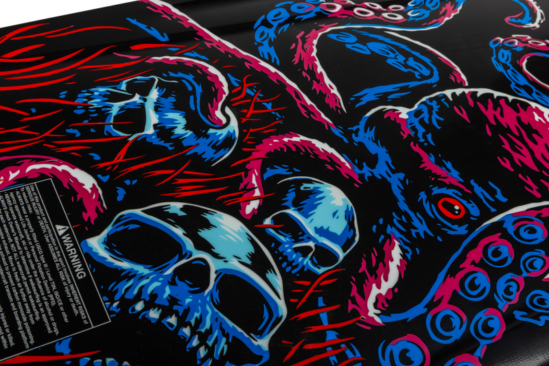 The Ronix Sea Captain Wakesurf Board 2026 by Ronix features a dynamic, stylized octopus with pink and blue tentacles and glow-in-the-dark skulls on black, enhanced by red accents and a warning label for an edgy, unique look.