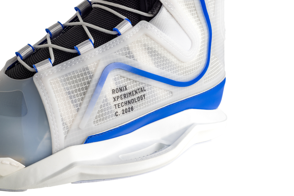 Close-up of the Ronix RXT Boots 2026, featuring a translucent upper, blue and white accents, black laces, and "RONIX EXPERIMENTAL TECHNOLOGY C. 2026"—designed with Mainframe 2.0 High Cut Technology for lightweight support.