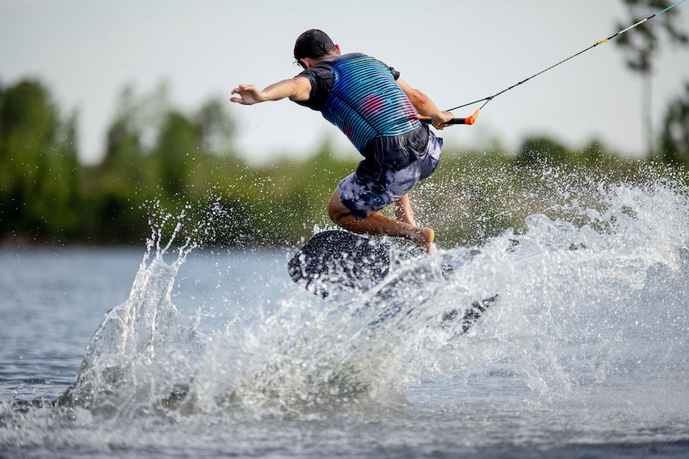 Ronix Rove Karver Wakeskate Action Shot of Pop Shuv trick