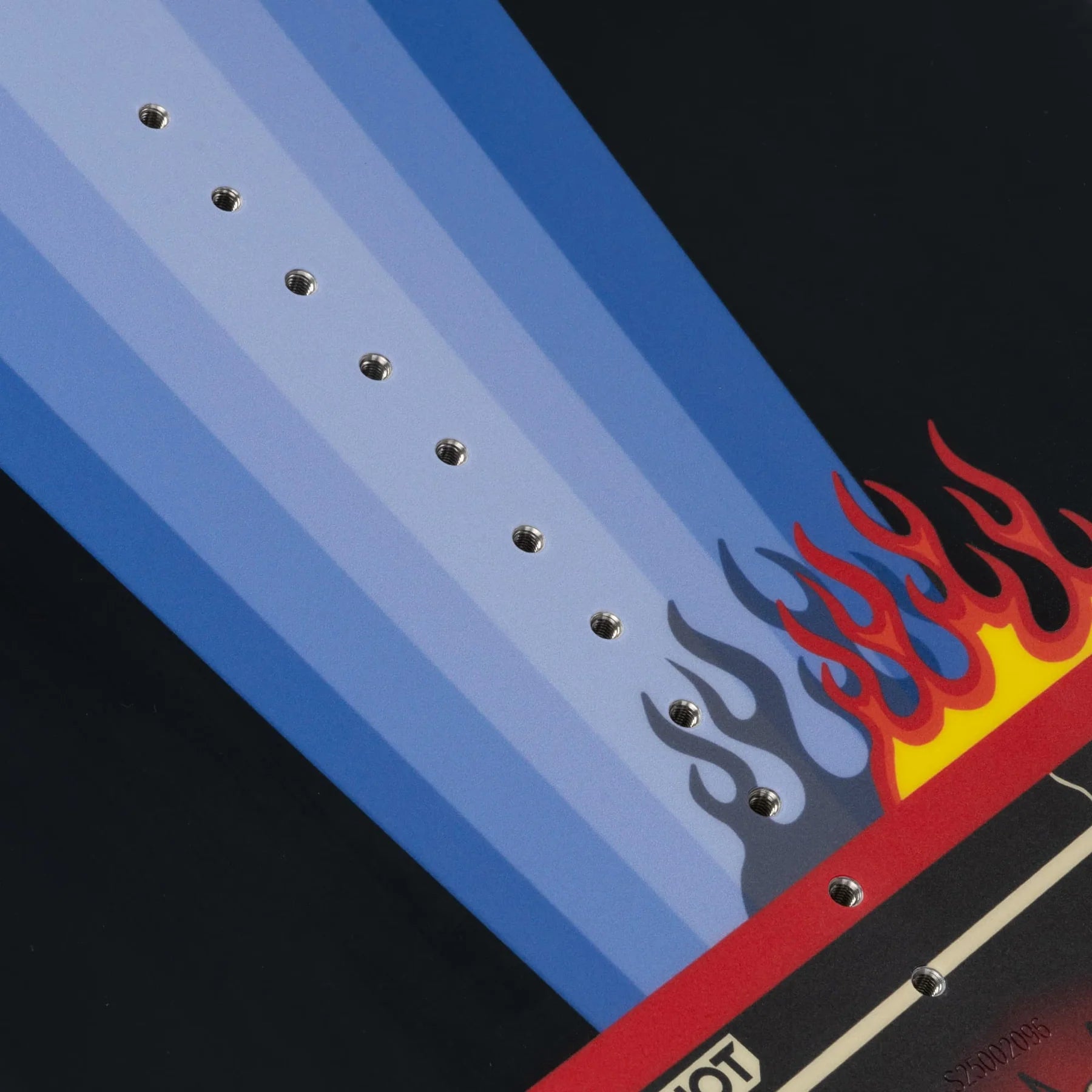 A close-up of the Slingshot 2025 Space Rover Wakeboard - 165cm showcases a striking blue and red flame design against a black background, highlighting its durable atomic wood core that adds both strength and style.