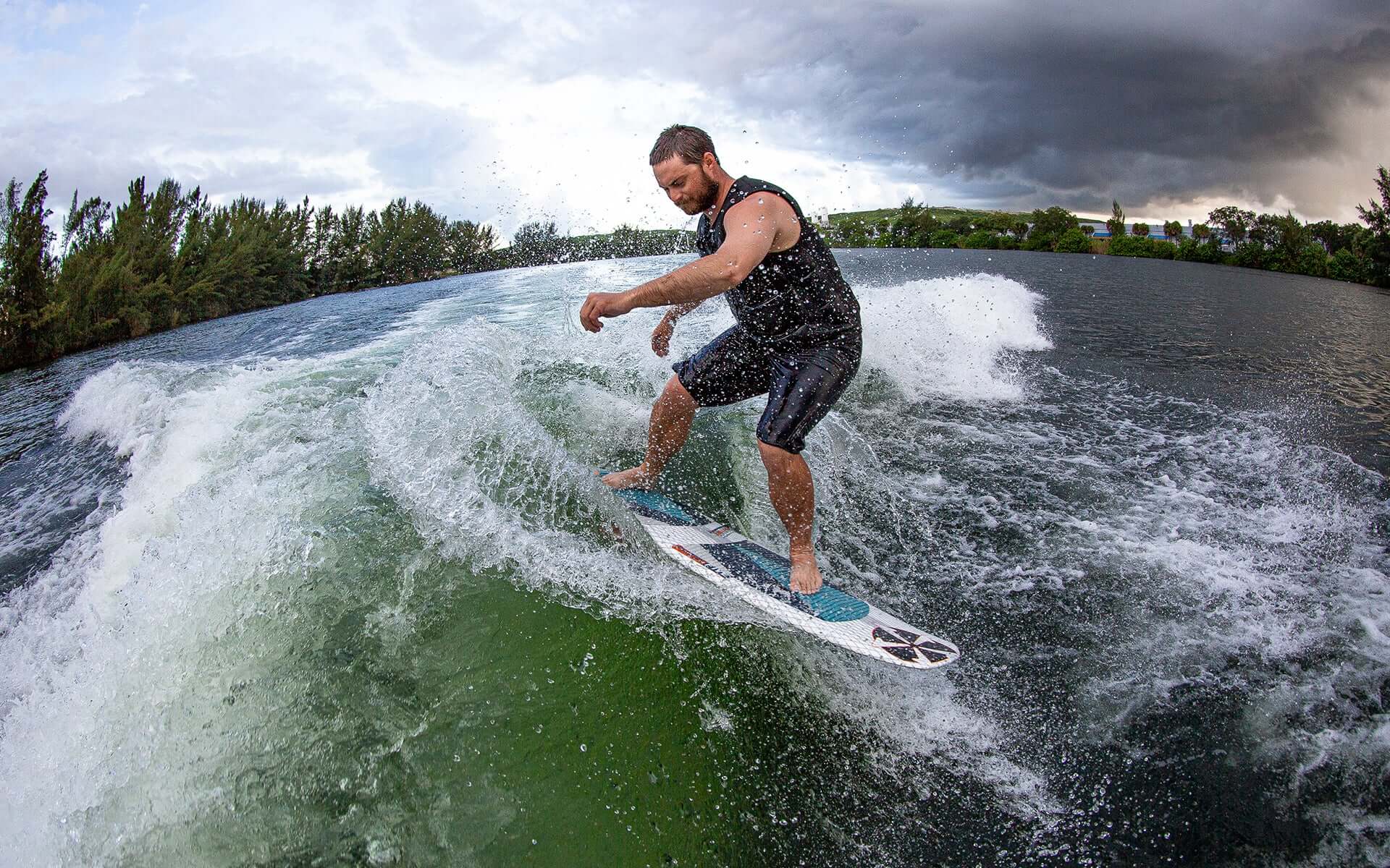 An experienced rider displaying stability and board control while riding a wave on a Phase 5 2024 Doctor Wakesurf Board.