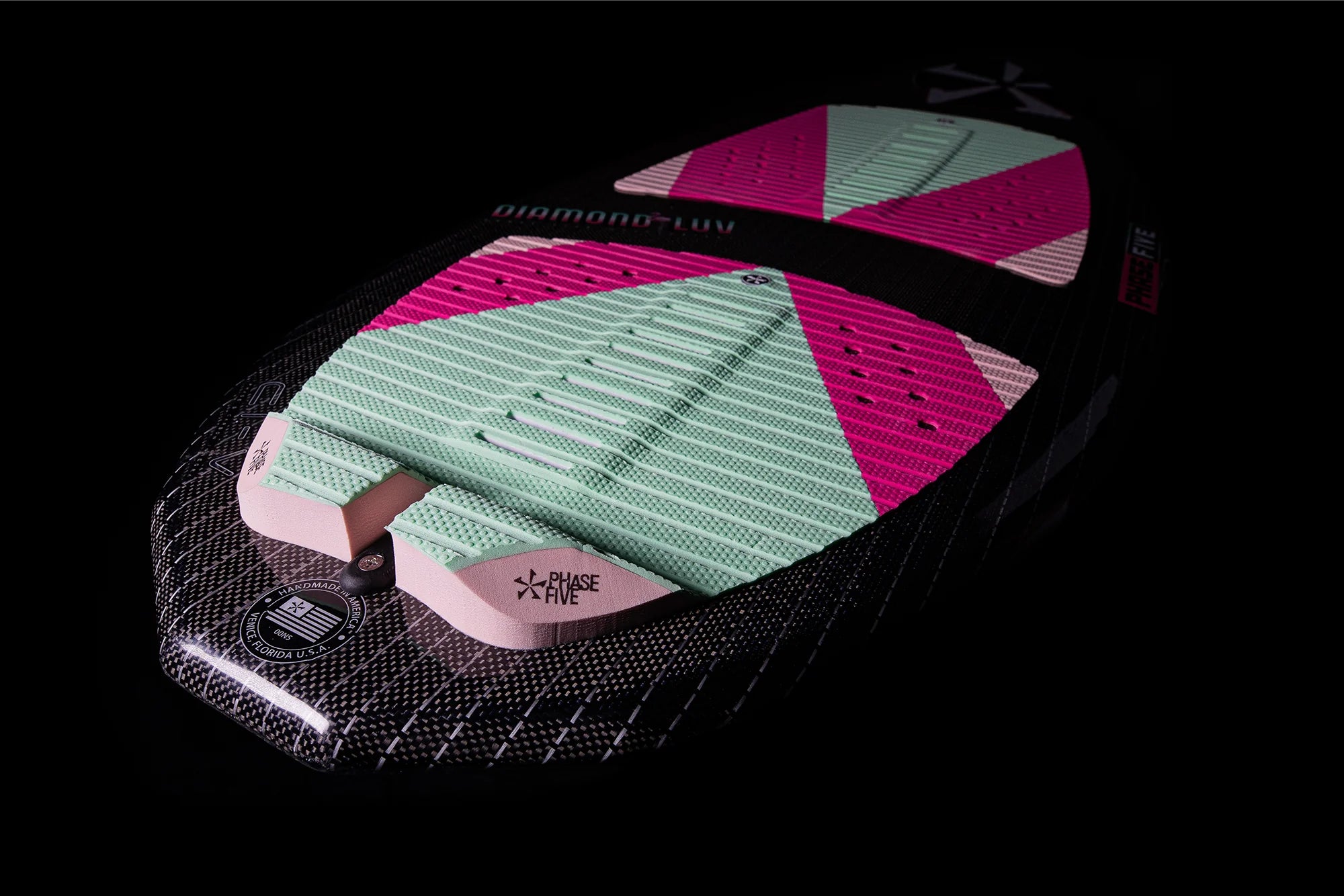 A pink Phase 5 2024 Diamond Luv Wakesurf Board on a black background.