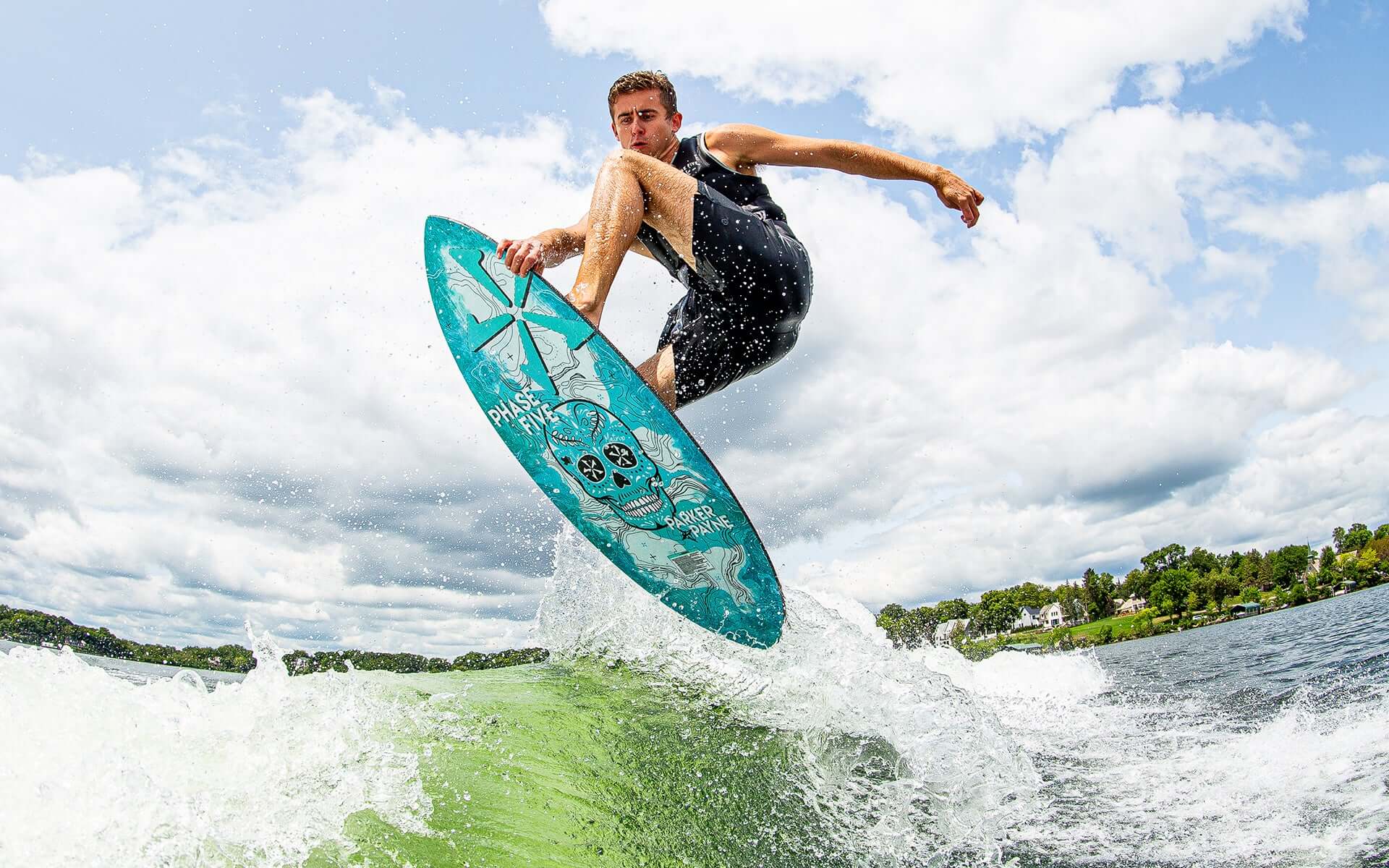 A man is riding a wave on a Phase 5 2024 Matrix Payne Pro Wakesurf Board with exceptional performance.