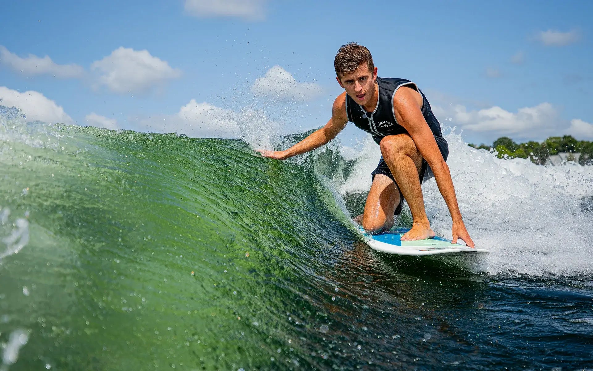 Phase 5 surfer Parker Payne effortlessly rides a wave on his Phase 5 2024 Phantom Wakesurf Board.