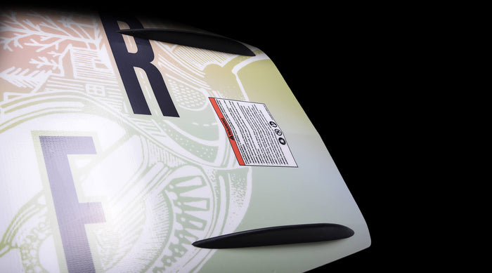 The back of a surfboard with a Hyperlite logo on it, featuring the Hyperlite 2024 Cadence Wakeboard design.
