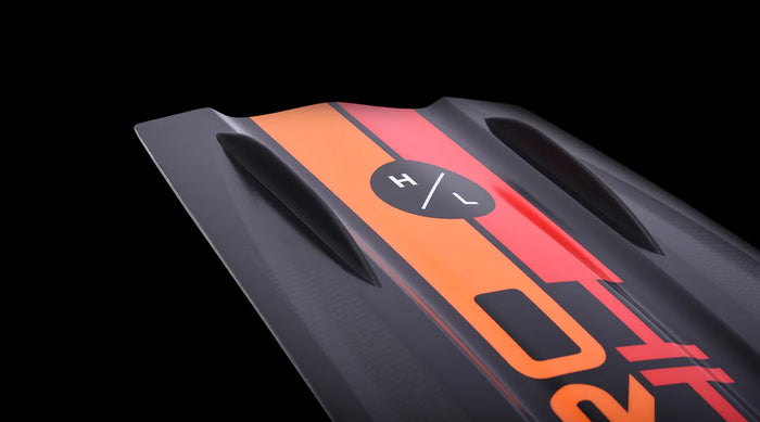 A close up of a Hyperlite 2024 Rusty Pro Wakeboard | Team OT Bindings with orange and black stripes.