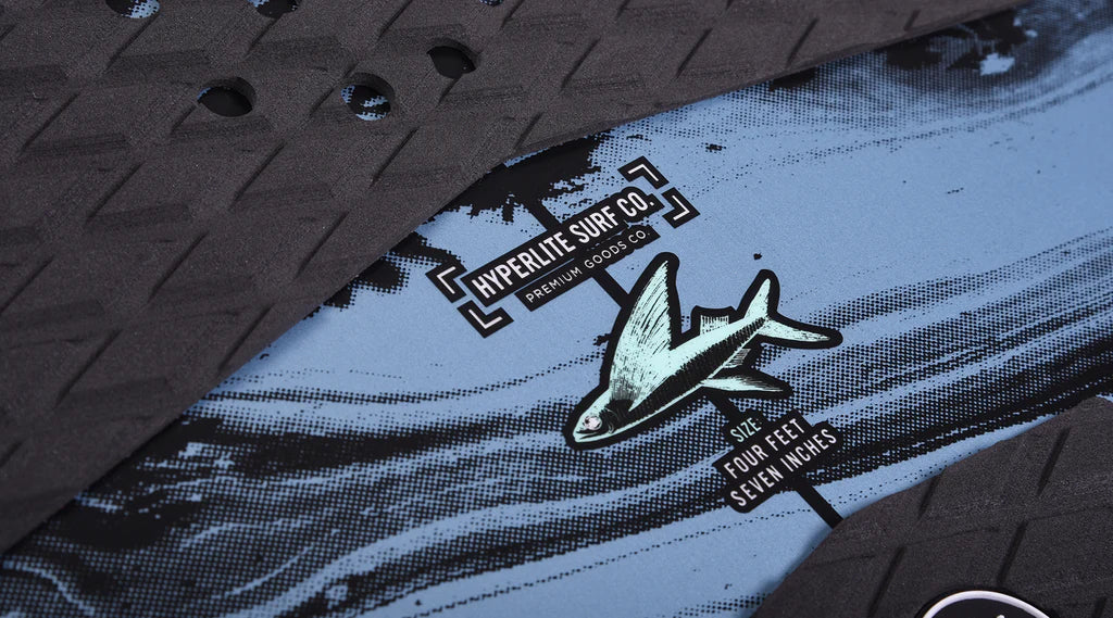 A close up of a Hyperlite 2024 Time Machine Wakesurf Board with a shark on it, showcasing surf style.