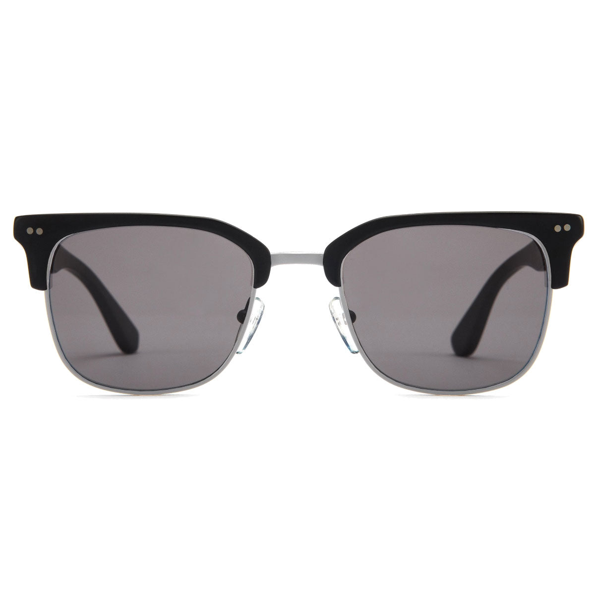 The Otis 100 Club - Matte Black/Grey Polar sunglasses by Otis feature a browline style with handmade matte black acetate frames, grey polarized lenses, and clear nose pads, shown facing forward against a white background.
