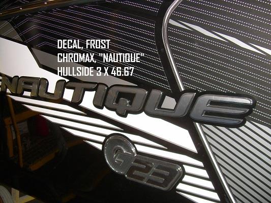 Close-up of a boat hull with bold, metallic Nautique FROST CHROMAX "NAUTIQUE" HULLSIDE Decal (3 x 46.67), part #130085 from Nautique, displayed beside stylized stripes.