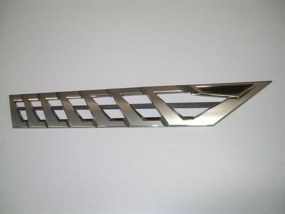 The Nautique DECAL VENT BRIGHT CHROMAX STARBOARD 3.85 X 23.59 - 170093, a chrome vent trim with diagonal slats and a pointed end, is shown against a plain white background.