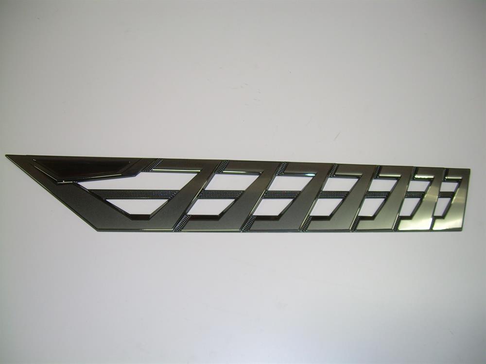 The Nautique DECAL VENT Black CHROMAX Port 3.85 X 23.59 - 170094 is an angular trim piece with geometric cutouts and a sleek black Chromax emblem, shown on a plain white background.