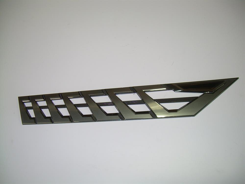 The Nautique DECAL VENT Black CHROMAX Starboard 3.85 X 23.59 - 170095, featuring a geometric cut-out design and sleek black finish, is displayed on a plain white background.