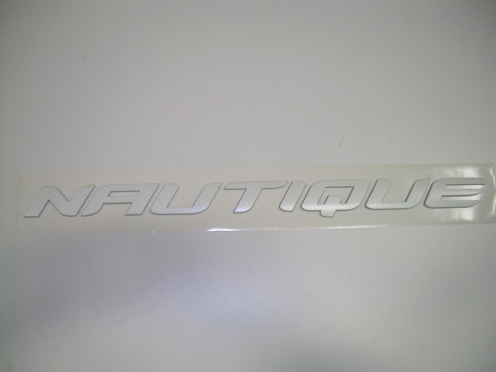 The Nautique DECAL TRANSOM CHROMAX WHITE 1.39 X 18 - 170277 is a bold, slanted, uppercase Nautique sticker—ideal as a white transom emblem for your boat.