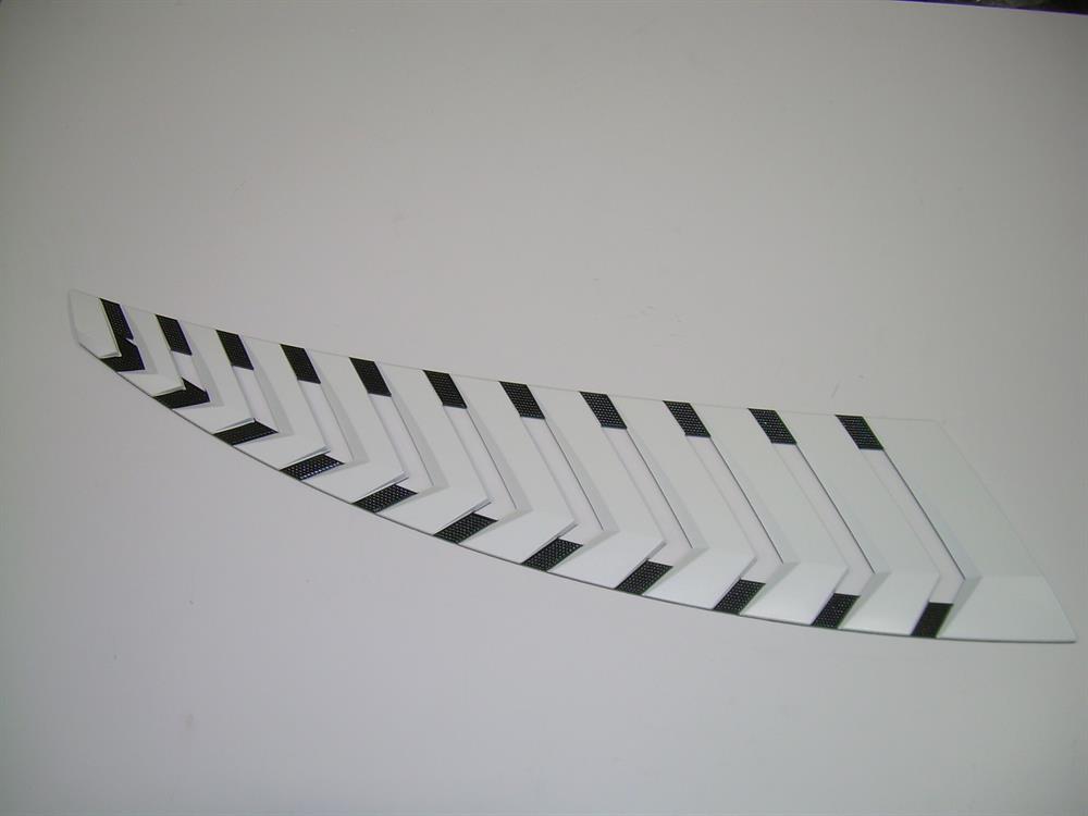 A Nautique DECAL G SERIES VENT PORT WHITE CHROMAX 8 x 27.75 (170300) featuring black chevron designs is shown against a plain white background.