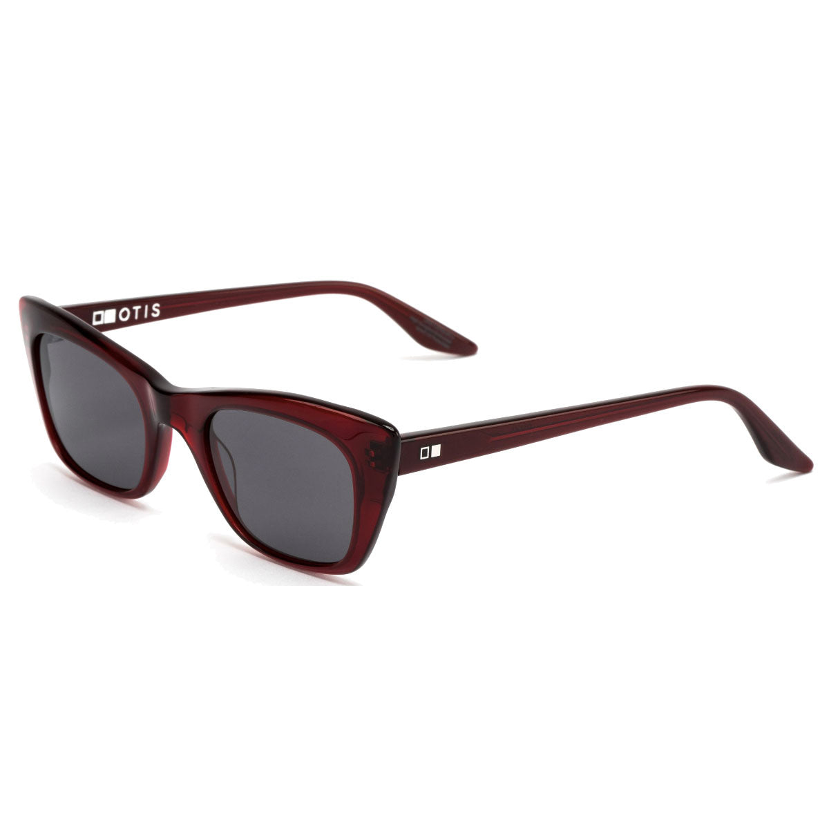 The Otis Suki - Cherry/Grey sunglasses have a dark red rectangular frame with grey mineral glass lenses, a small square logo and OTIS branding on the left arm. Slightly curved arms ensure comfort and UV protection.
