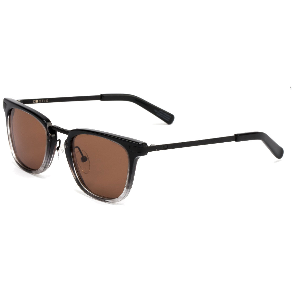 Otis the Talk - Smoke Gradient/Brown Polar sunglasses by Otis feature an acetate metal frame, black arms, and brown gradient mineral glass lenses with 100% UVA/UVB protection, displayed at an angle on a white background.