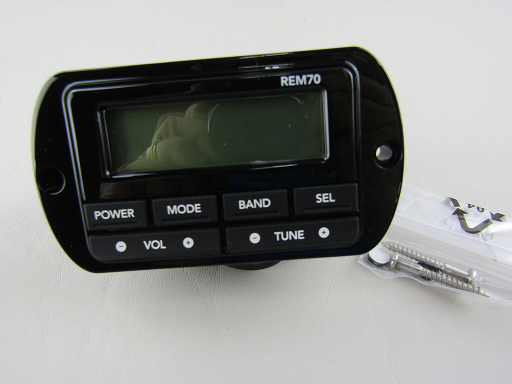 The Malibu Remote Transom w/ Display (3910435)—a black OEM device with screen and buttons (Power, Mode, Band, Sel, Vol, Tune)—comes with screws and suits Malibu & Axis boats, shown on a white surface.