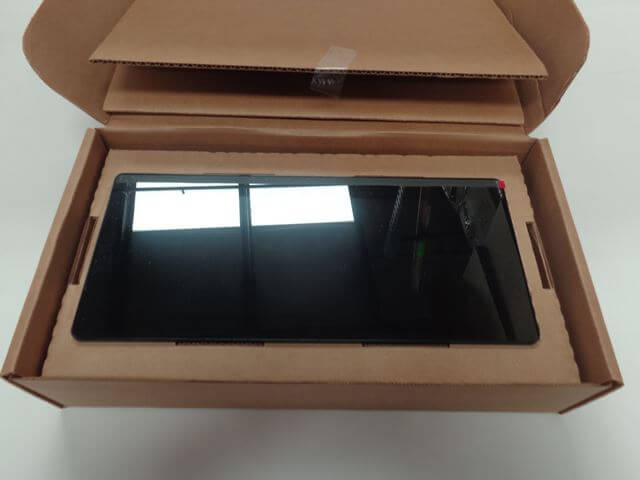 A Malibu Touch Screen Display - Main/Center, 12", '15 (3962055.1) by Malibu is placed inside an open cardboard box with the lid partially open, resting on a white surface.