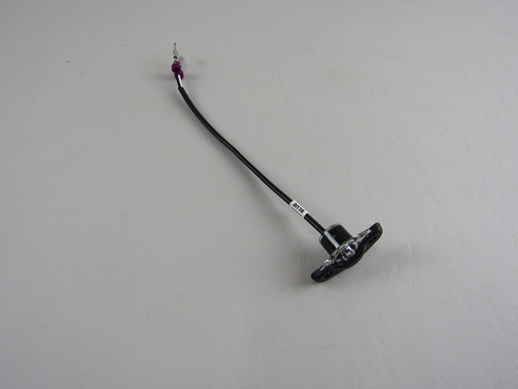 The Axis Underseat LED Light- Blue, '18- by Axis is a black cable with a rectangular mounting base and a metal connector with a purple section, designed for underseat light installation in Axis boats.