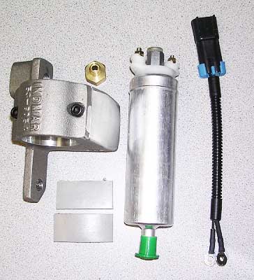 The Indmar Pump Fuel PFI - P/M + 8 HOLE - 495117 by Indmar includes a silver cylindrical fuel pump, metal bracket, black wiring connector, brass fitting, and two metal spacers, all displayed on a light speckled surface.