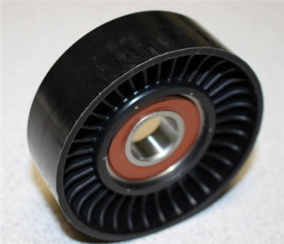A close-up of the Indmar PULLEY, IDLER NON-GROOVED 6.2L FORD - 551499 by Indmar, featuring a black plastic body and metal center, designed for 6.2L Ford engines, displayed on a light surface.